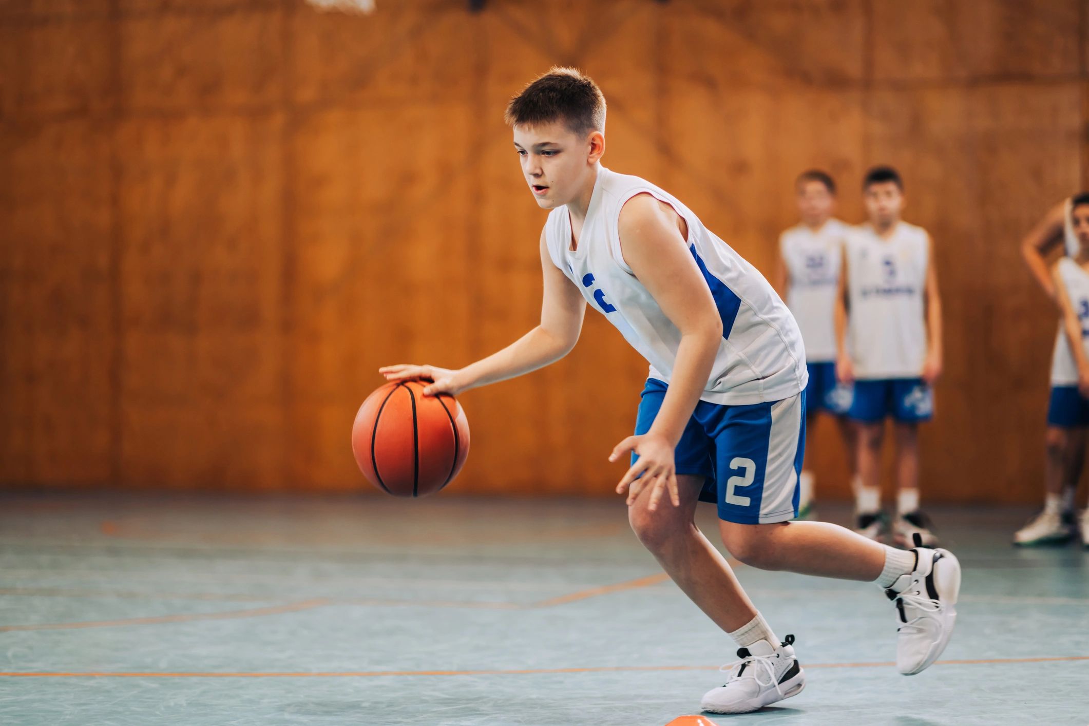 Young basketball player making a jump shot