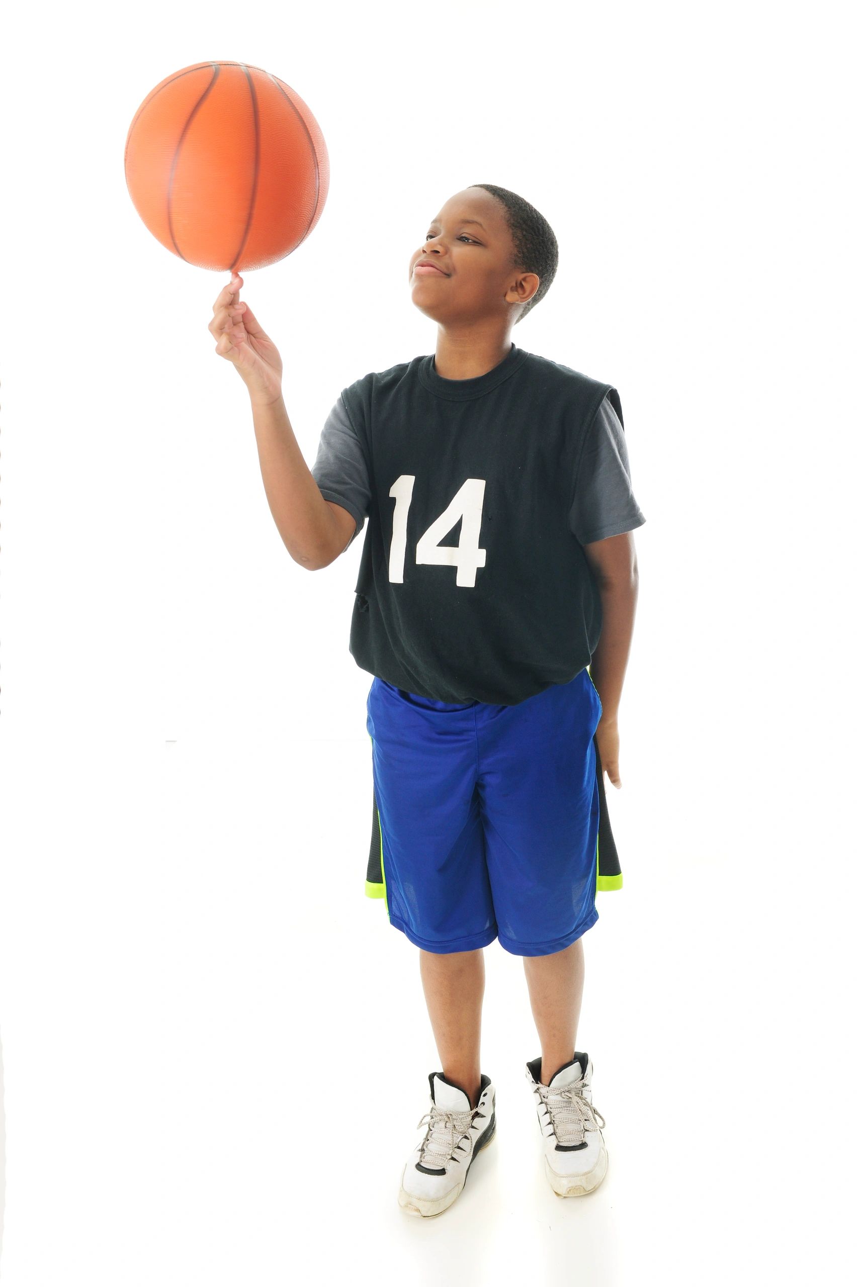 Preteen boy with basketball smiling